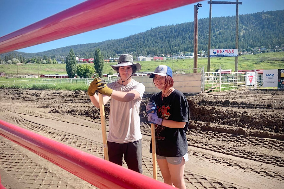 Tolson Waters, on left, and Brianna Irawan are Williams Lake Stampede Association summer employees and were helping to do the dirty work of shovelling the edges of the arena down to grade. (Ruth Lloyd photo - Efteen)