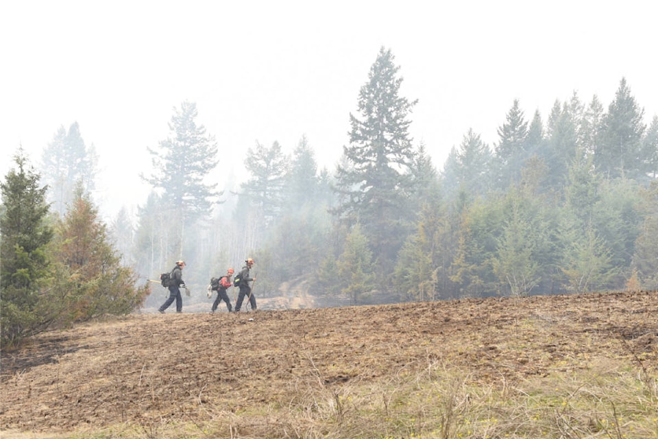 Firefighters head out of the burn after supporting the controlled burn below Westridge subdivision in Williams Lake last spring. (Ruth Lloyd photo - Williams Lake Tribune)