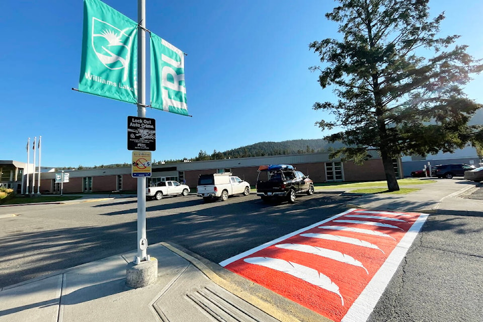 A new crosswalk in orange and feathers was painted at TRU in Williams Lake the week of Aug. 30 to welcome students back to the campus. (Ruth Lloyd photo - Williams Lake Tribune)