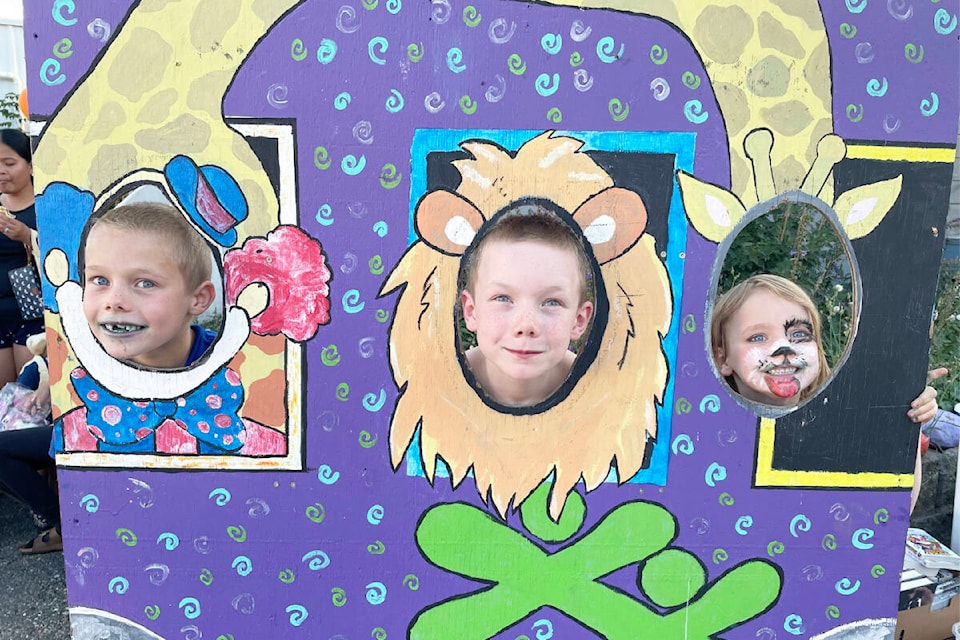 Kalen, from left, Gregory, and Amelia Ambrose were enjoying the circus-themed photo booth at the BGC street party in Williams Lake Aug. 31. (Ruth Lloyd photo - Williams Lake Tribune)