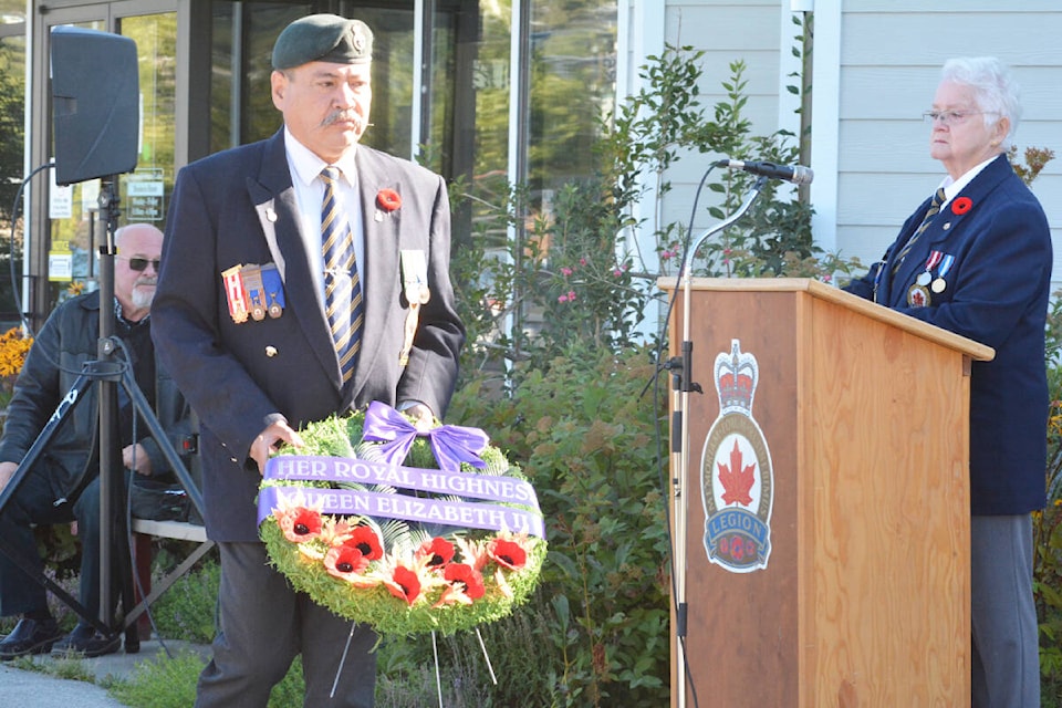 People line up to place poppies on a wreath prepared for Queen Elizabeth II Monday, Sept. 19 outside Williams Lake City Hall. (Monica Lamb-Yorski photos - Efteen) Royal Canadian Legion first vice-president Gord Keener prepares to lay a wreath at the cenotaph during a ceremony hosted by the Royal Canadian Legion Branch 139 in honour of Queen Elizabeth 11, while MC Vivian McNeil looks on. (Monica Lamb-Yorski photo - Efteen)