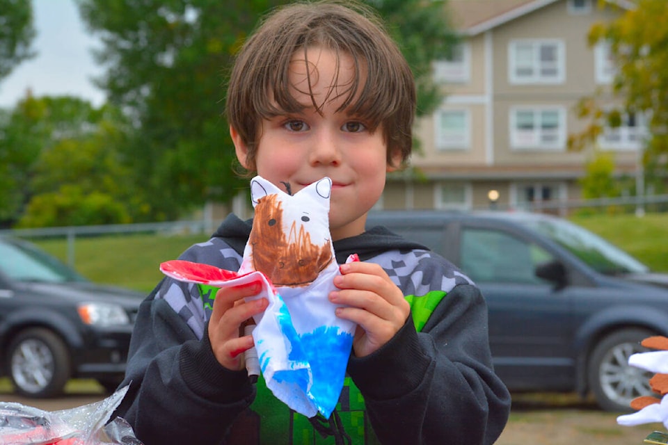 Alex Rose Shorter, 5, paints herself a puppet during the Take Back the Night event Friday, Sept. 23 in Williams Lake. (Monica Lamb-Yorski photo - Williams Lake Tribune)