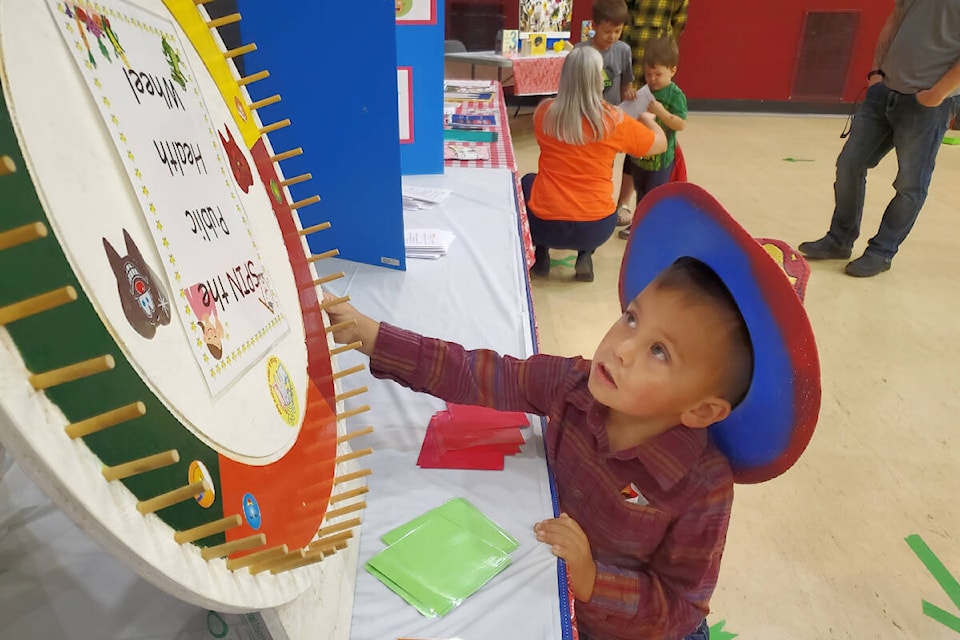 Jonas William, 3, spins the wheel at the audiology table during the 3 Year Old Round Up Saturday, Sept. 24 in Williams Lake. (Monica Lamb-Yorski photo - Williams Lake Tribune)
