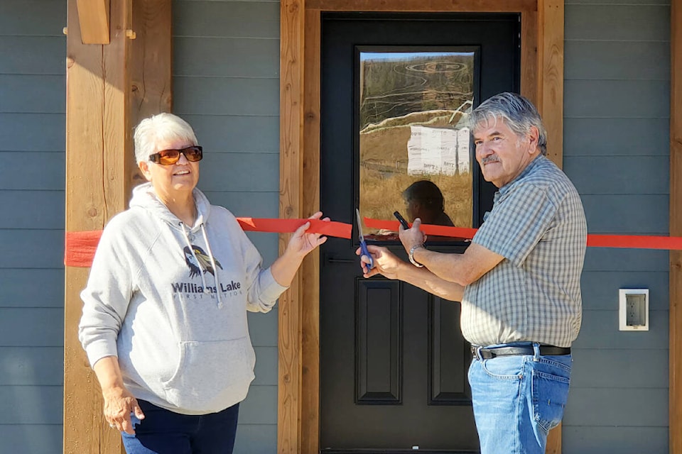 Williams Lake First Nation councillors Ann Louie, left, and Rick Gilbert cut the ribbon for a new net zero duplex at Sugar Cane. (Monica Lamb-Yorski photo - Williams Lake Tribune)