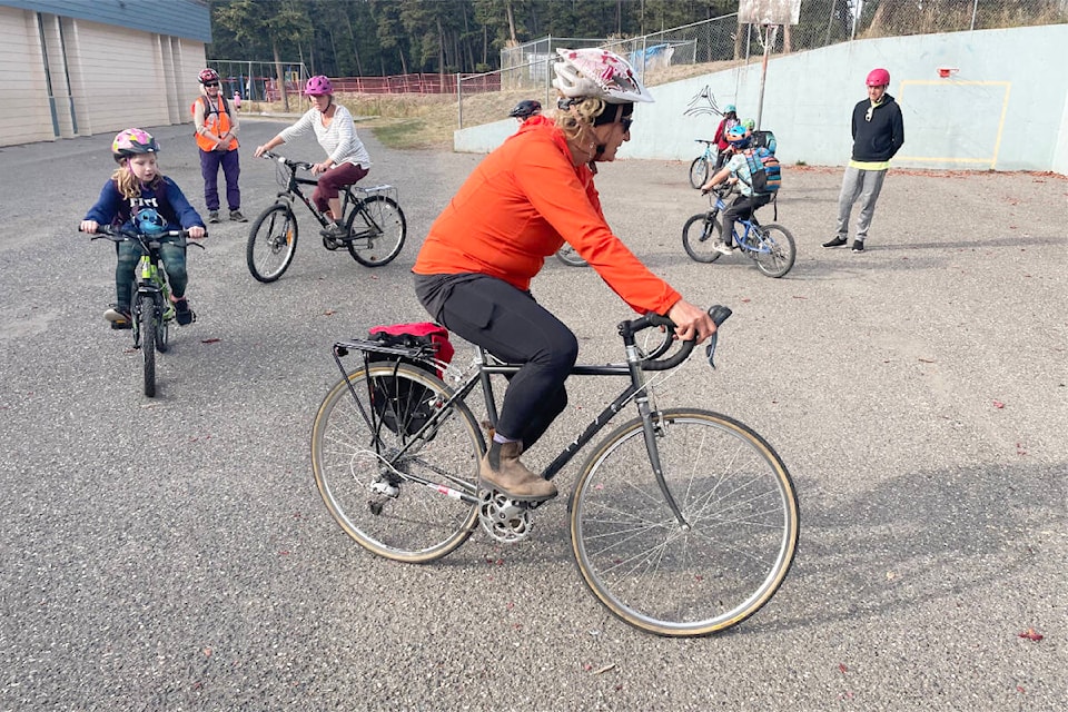 Volunteers and students practice some bike skills at Cataline Elementary School before heading out on their return ride home from school Friday as part of Williams Lake’s first ever “bike bus” for Go By Bike Weeks. (Ruth Lloyd photo - Williams Lake Tribune)