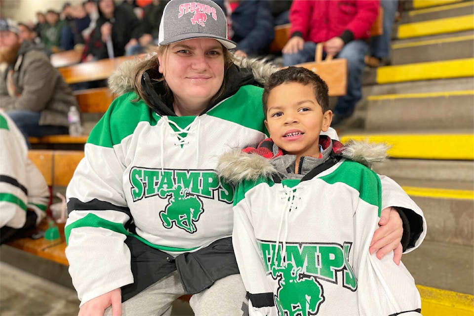 Angelina Logan and Elias Harris were showing their team spirit as they cheered on the Stampeders at a home game on Dec. 10, 2022 in Williams Lake. (Ruth Lloyd photo - Williams Lake Tribune)