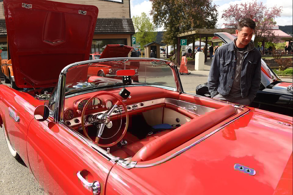 Chad Baba takes time to check out a T-bird convertible, one of the many vehicles entered in the Lakers Car Club Annual Spring Roundup Show and Shine on May 29, 2022 in Williams Lake. (Ruth Lloyd photo - Efteen)