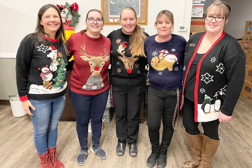 Roberta Smith, from left, Joanna Smith, Jessica Hoeft, Tari Davidge, and Tamara Robinson, all wore their Christmas sweaters to serve Christmas lunch at the Salvation Army on Dec. 22. (Ruth Lloyd photo - Williams Lake Tribune)