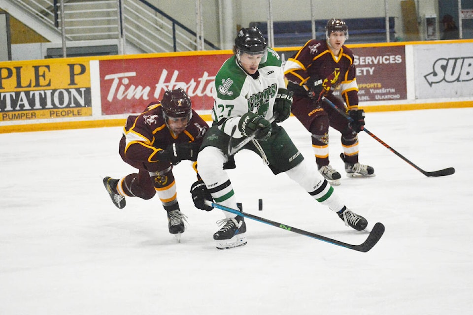 Williams Lake Stampeders forward Cole Zimmerman leans in for the puck against his Quesnel Kangaroos opponent Saturday, Jan. 7 during a home game. (Monica Lamb-Yorsk photo - Williams Lake Tribune)