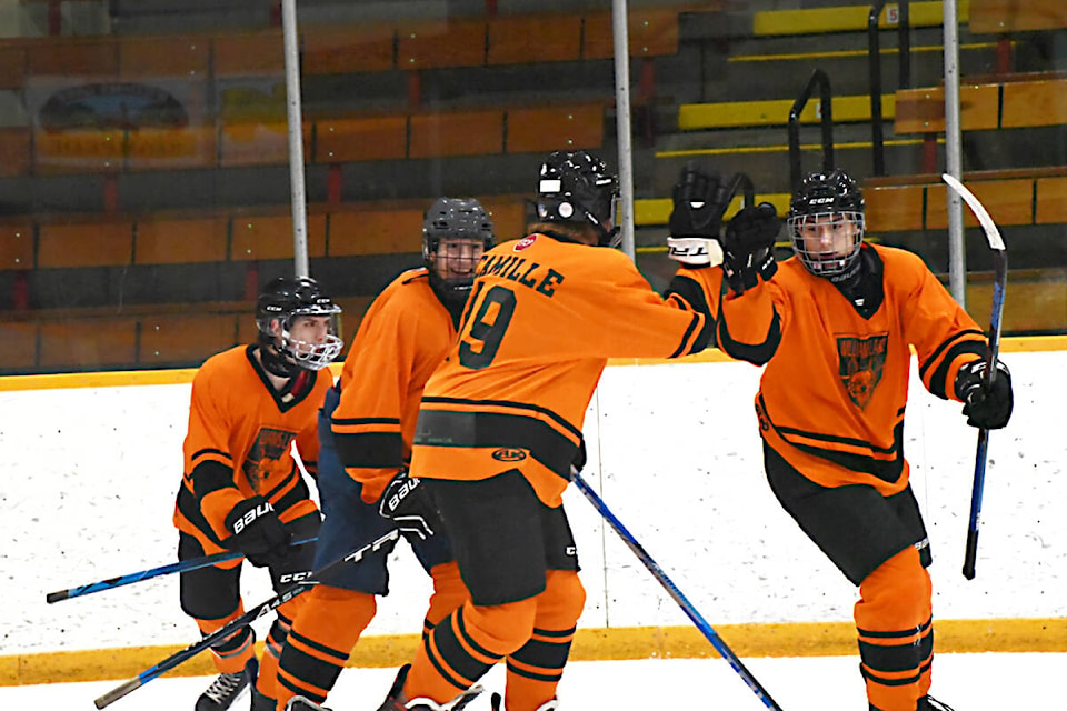 Williams Lake’s U18 orange team celebrates after getting a goal against their opponents Jan. 13 in Rink 1. (Angie Mindus photo - Williams Lake Tribune)