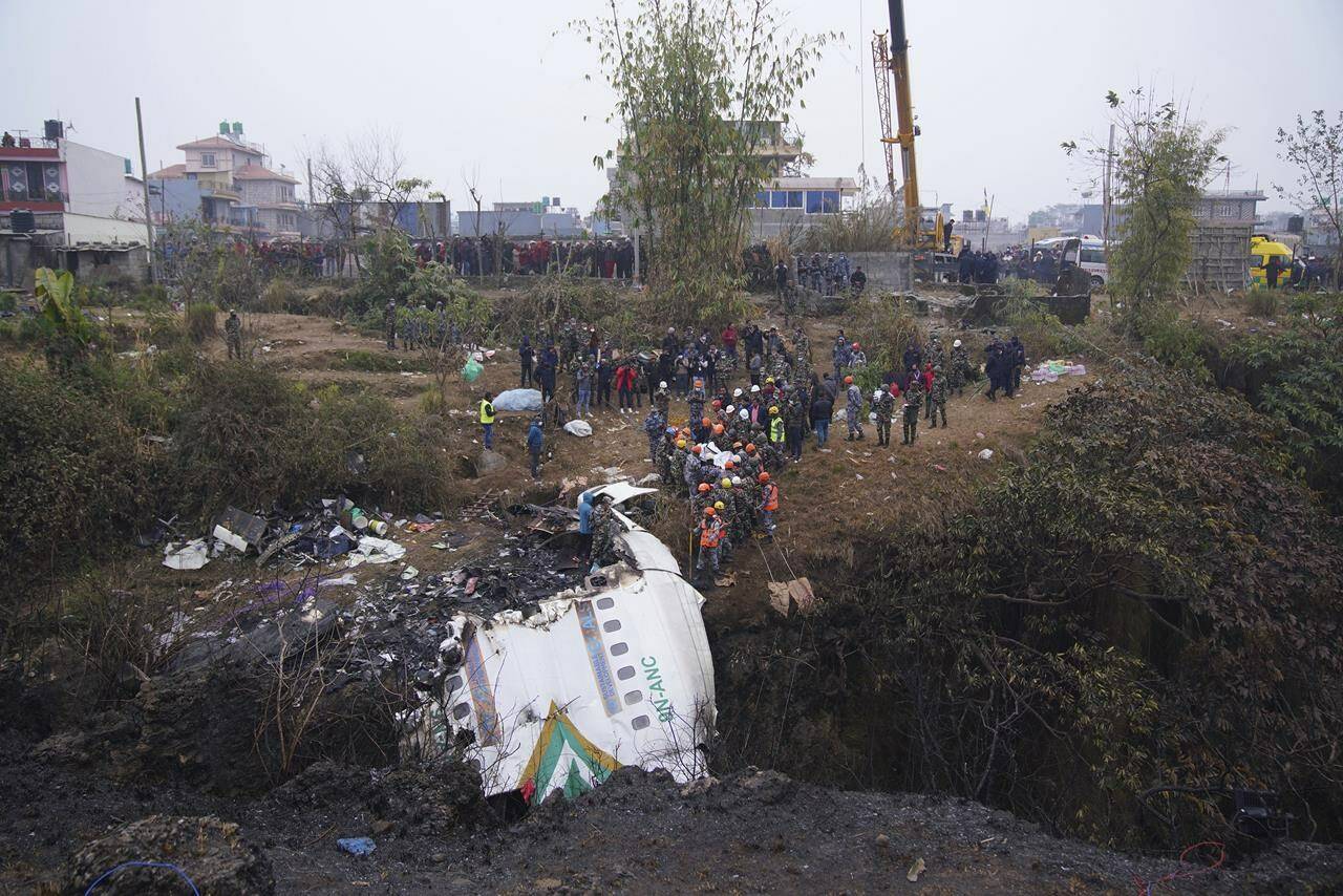 Rescuers scour the crash site in the wreckage of a passenger plane in Pokhara, Nepal, Monday, Jan.16, 2023. Nepal began a national day of mourning Monday as rescue workers resumed the search for six missing people a day after a plane to a tourist town crashed into a gorge while attempting to land at a newly opened airport, killing at least 66 of the 72 people aboard in the countrys deadliest airplane accident in three decades. (AP Photo/Yunish Gurung)