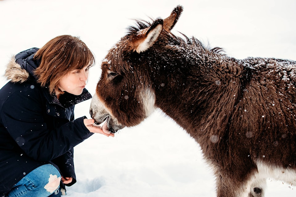Photographer Laureen Carruthers pictured with her miniature donkey. (Joel Gyselinck photo)