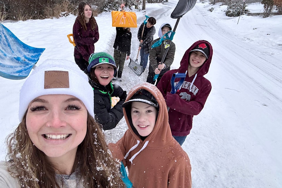 Ashleigh Lyons, in front, and some of her Grade 7 Columneetza class were out shovelling neighbourhood driveways on Jan. 24, 2023. (Ashleigh Lyons photo)
