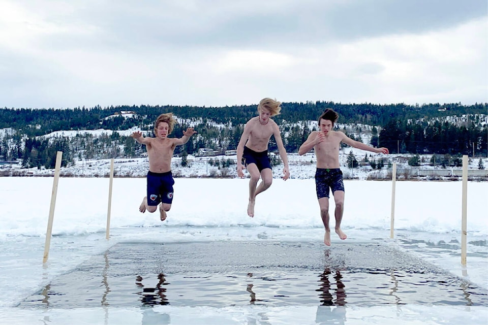 Linden Pinette, from left, Chaz Lucas, Carter Krueger jump in at the Freezin’ for a Reason polar bear plunge in Williams Lake at Scout Island on Feb. 4, 2023. (Ruth Lloyd photo - Efteen)