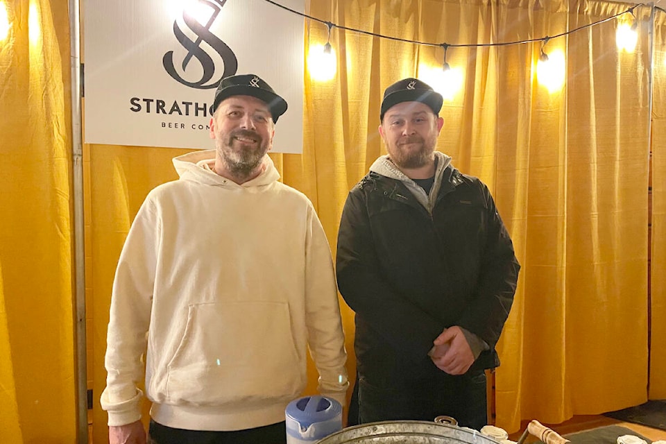 Strathcona Beer Company’s Adrian McInnes and Nick Nazarac were serving at a booth at the Williams Lake Craft Beer Festival on Feb. 11, 2023 at Thompson Rivers University. (Ruth Lloyd photo - Efteen)