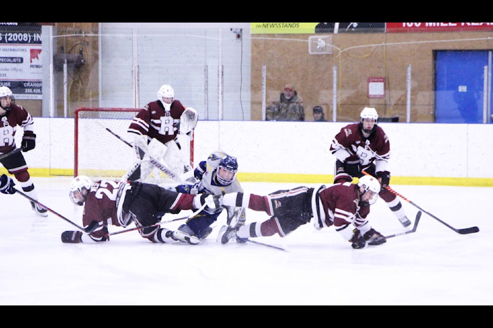 100 Mile House Wrangler Jace Myers shoves himself to his feet after being tripped up by two Revelstoke Grizzlies. (Patrick Davies photo - 100 Mile Free Press)