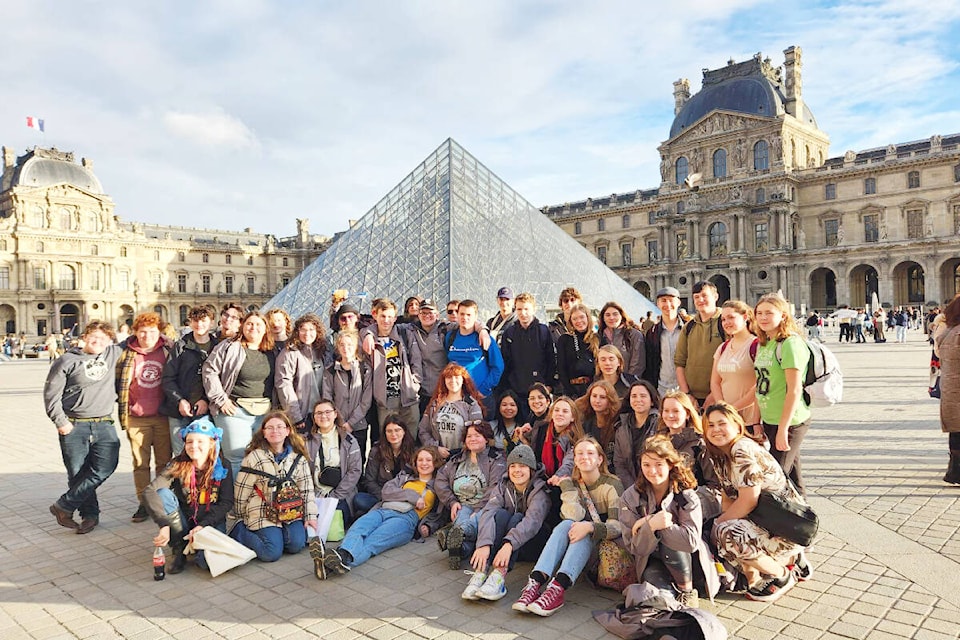 Lake City Secondary Students pose for a photo op in front of the Louvre Museum in Paris, France while on a band tour of parts of Europe over part of spring break. (Dena Baumann photo)