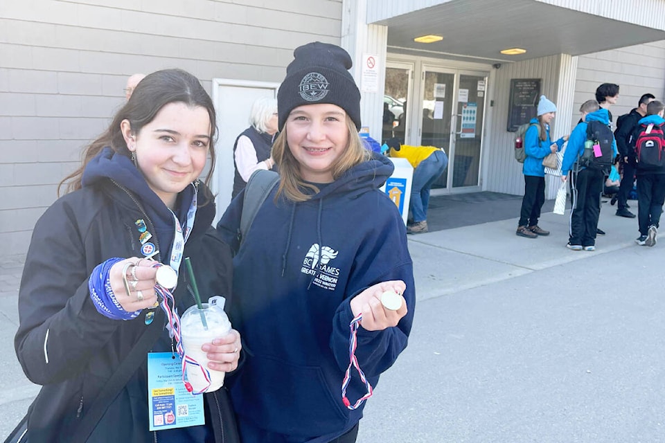 Talana Brown-John, left, and Kelsey Camille hold up the medals they won on a mixed doubles team competing at the BC Winter Games in Vernon. (Photo submitted)