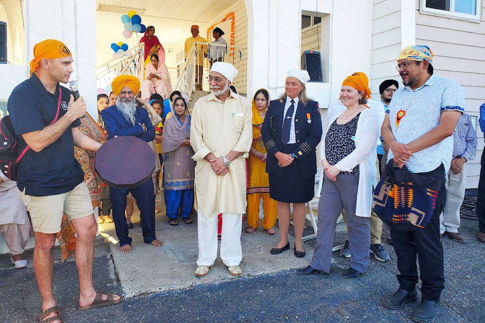 Williams Lake First Nation Chief Willie Sellars, left, presents Mayor Surinderpal Rathor, with the gift of a drum with councillors Joan Flaspohler, Sheila Boehm and Michael Moses watching on Saturday, April 29 outside Guru Nanak Sikh Temple during a Vaisakhi celebration. (Monica Lamb-Yorski photo - Efteen)