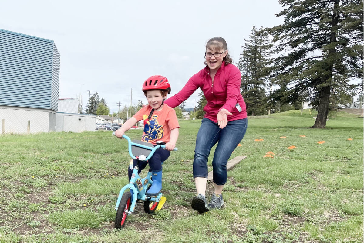 Eli Frederick looks to be having a blast at the Streets for All Williams Lake with his mom Erins help. (Ruth Lloyd photo - Efteen)