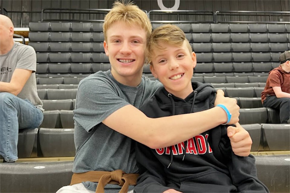 Niko Grondines, left, encourages Lincoln Hoelzler as he competed over two days at the WKU National Championships in Calgary, Alta. (Photo courtesy of Shogun Martial Arts)