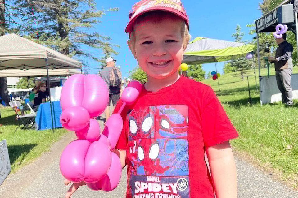 Nathan Helmer was very happy with his balloon dog thanks to the magical hands of Clint Gray at the Williams Lake Children’s Festival on May 28. (Ruth Lloyd photo - Efteen)