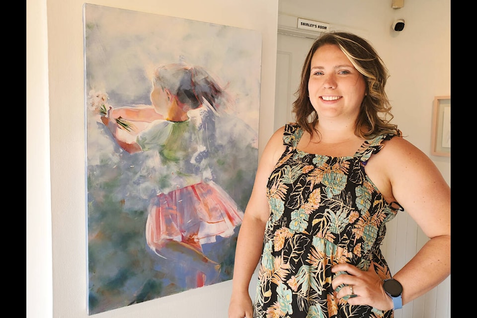 Williams Lake artist Sarah Sigurdson with her piece Grandma’s Garden in her first solo exhibit, now showing at the Station House Gallery. (Monica Lamb-Yorski photo - Williams Lake Tribune)