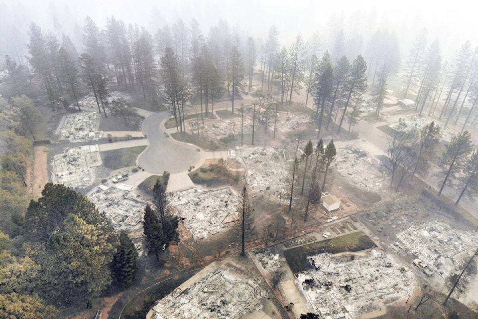 A tightly-packed subdivision devastated by a wildland-urban fire with green trees still standing adjacent to homes burned to the ground eludes to the cause of property destruction being the vulnerability of homes and materials found immediately around them to ignition by embers carried on the wind from the wildfire, not contact with direct flames or radiant heat of the burning forest or grassland. (Photo courtesy of Jack Cohen).