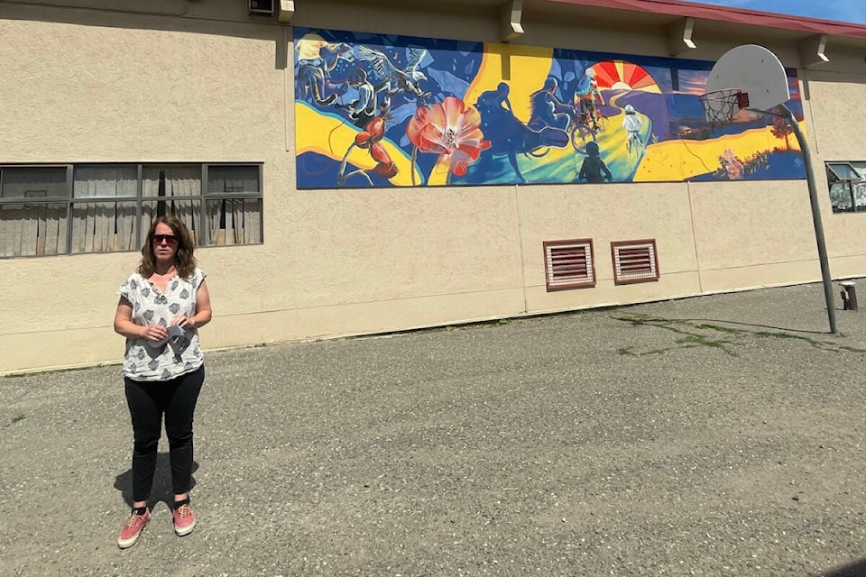 Jane Wellburn, with the Chilcotin Road Parent Advisory Council, addresses the crowd at the unveiling of a new mural at the elementary school in June. (Ruth Lloyd photo - Efteen)