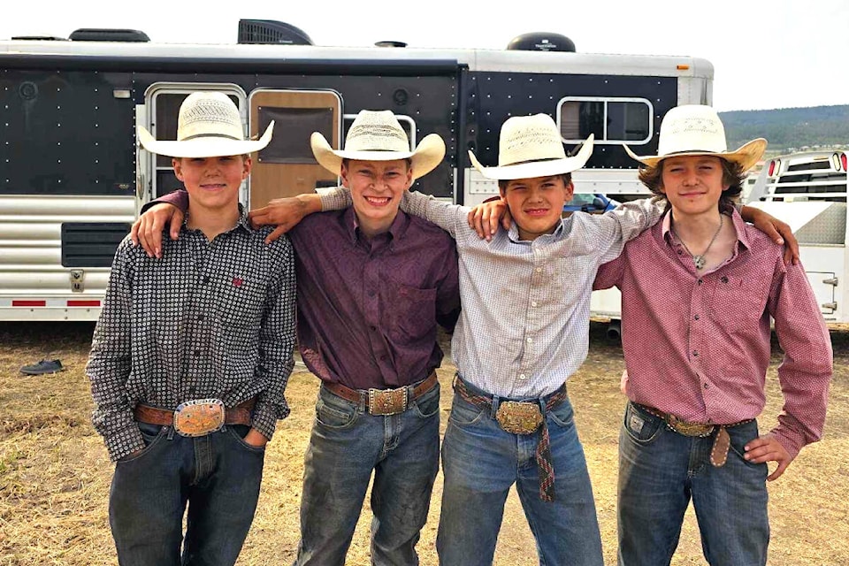 Turner James, Tel Lytton, Tanner Loring and Colby Ignace look the part of a cowboy after throwing the chute dogging cattle. (Shelly Loring photo)