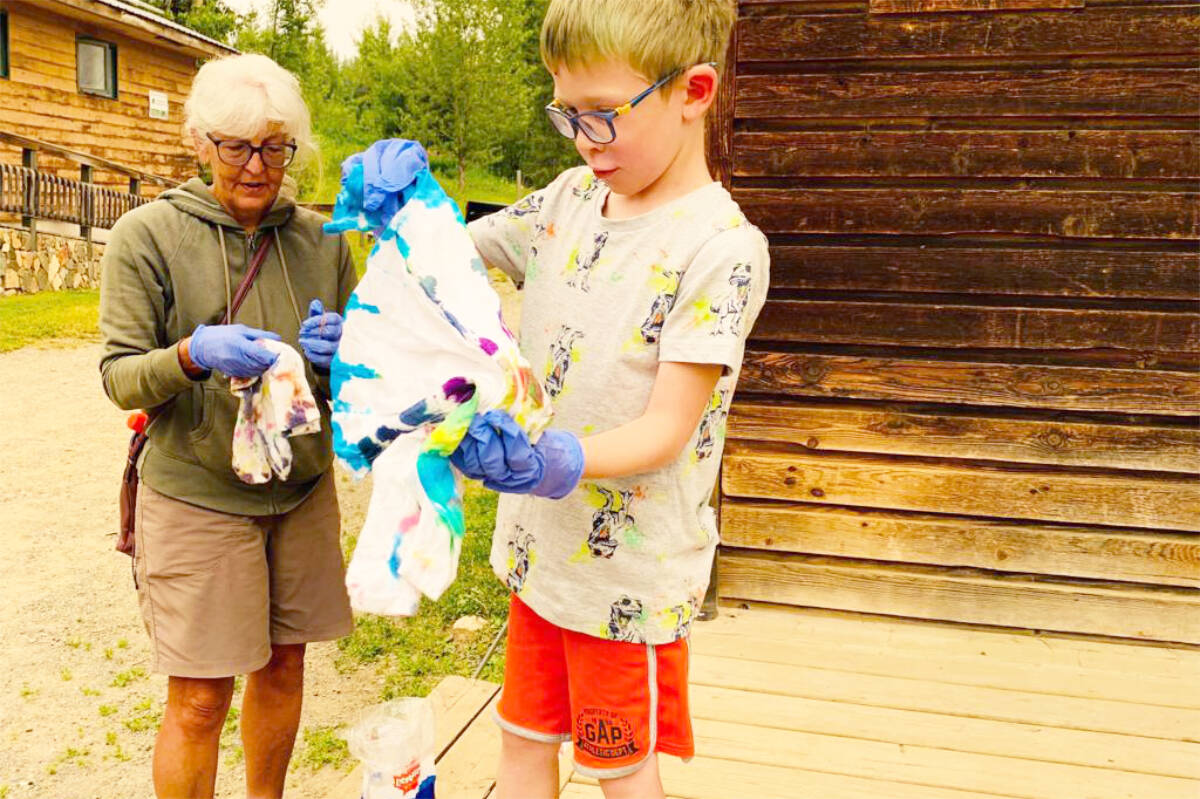 Frances Brown and her grandson Kais unveil the tie-dye creations they made during Grandparent Camp July 11-13. (Gavin Lake Forest Education Society photo)