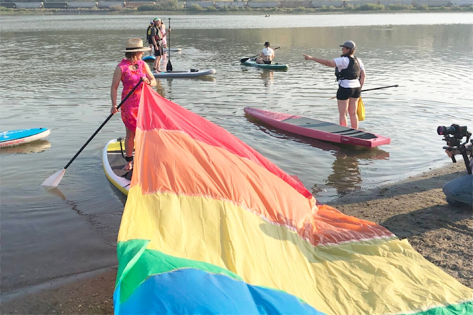A large rainbow train was towed along for part of the Pride Paddle organized by SUP in the Puddle on Aug. 16 on Williams Lake. (Caroline Derksen photo)