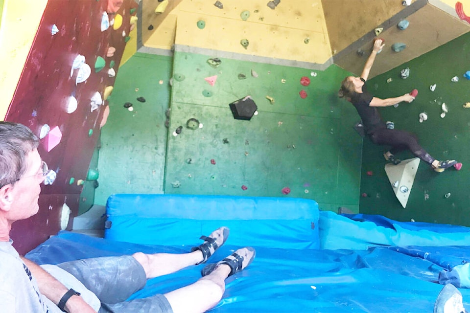A climber works on a problem while other climbers watch during the Fall off the Wall bouldering competition at Gavin Lake on Sept. 9, 2023. (Photo submitted)