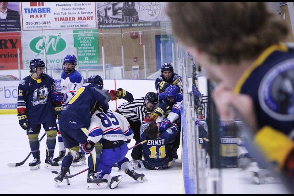100 Mile House Wangler Mason PIncott peers out from the penalty box as a brawl breaks out between the Wranglers and Creston Valley Thundercats. (Patrick Davies photo - 100 Mile Free Press)