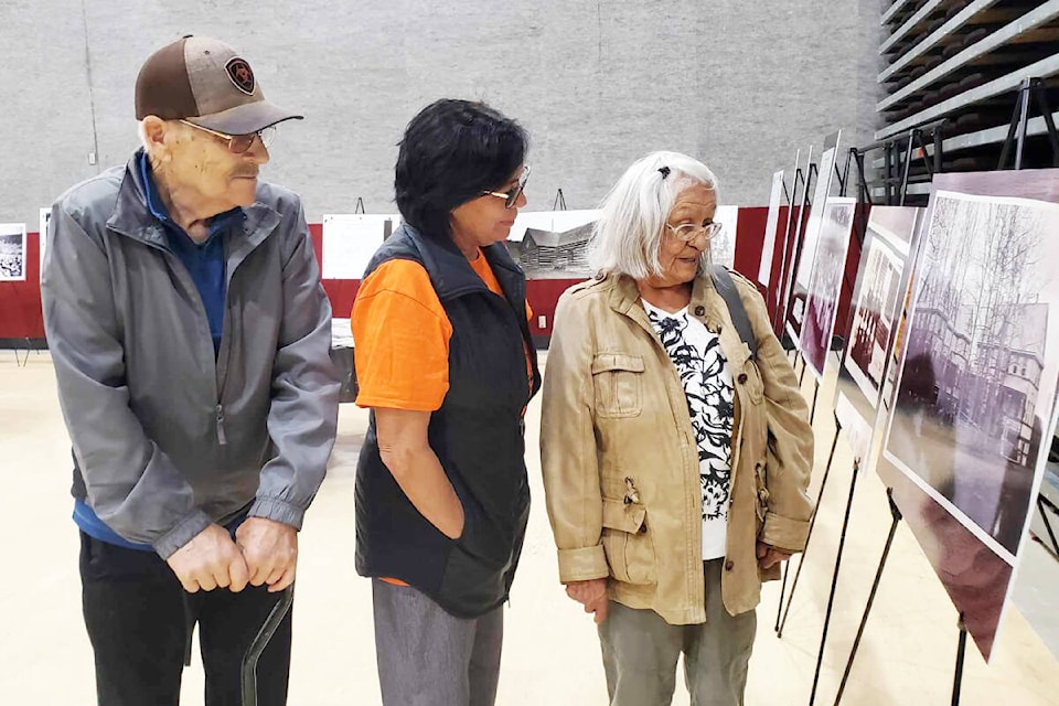 Martha Sure, right, joined by her husband William Sure, left, and her daughter Norma Sure takes in the historic photo display from St. Joseph’s Mission Residential School at the Gibraltar Room Sept. 25 to Sept. 29. Martha was a student at the school for eight years. (Monica Lamb-Yorski photo - Williams Lake Tribune)