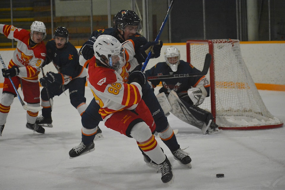 Mustangs Asher Lucas fights for control of the puck Saturday, Dec. 14 against the Beaver Valley Nitehawks in Williams Lake. 