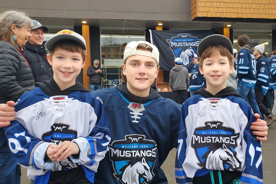 Williams Lake Mustangs forward Asher Lucas poses with fans and twin brothers  Emmett Sayenchuk, 7, and Rylan Sayenchuck, 7, at the community appreciation barbecue hosted by the team Monday, March 10. 