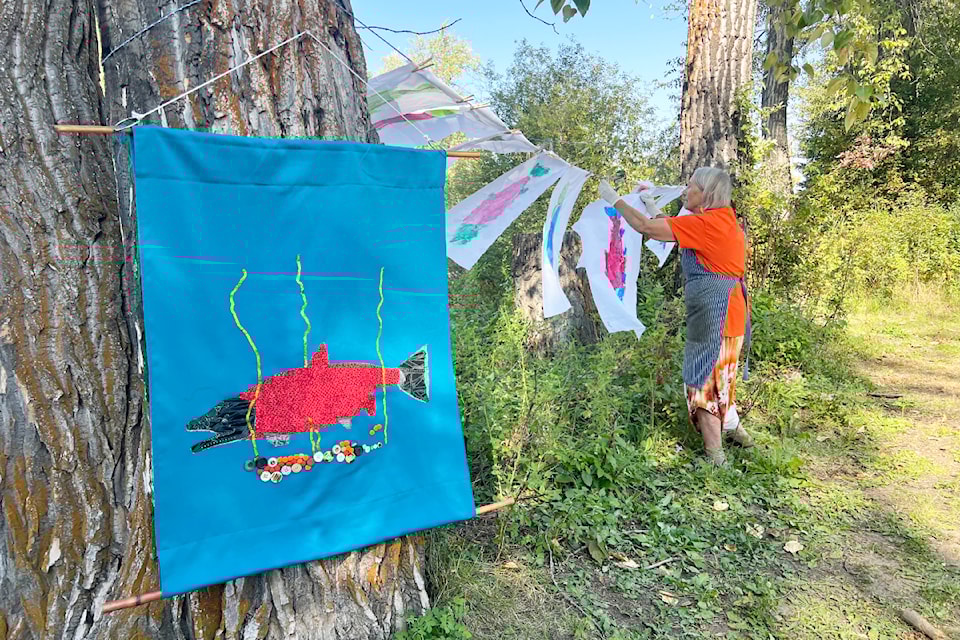 Beautiful banners and Gyotaku fish prints hang in the sun on Saturday, September 7 in Horsefly.