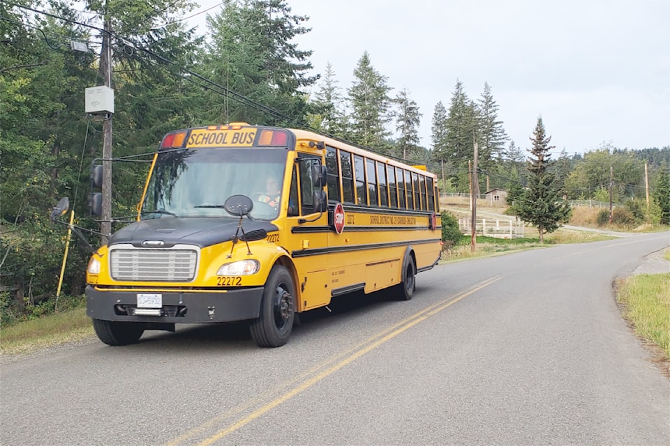 A School District 27 school bus heads along South Lakeside Drive to pick up students before class.