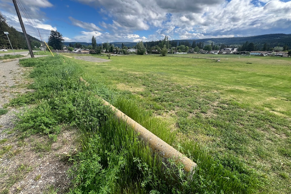 A vacant property where Poplar Glade Elementary School previously stood with Kinsmen Park in the background.