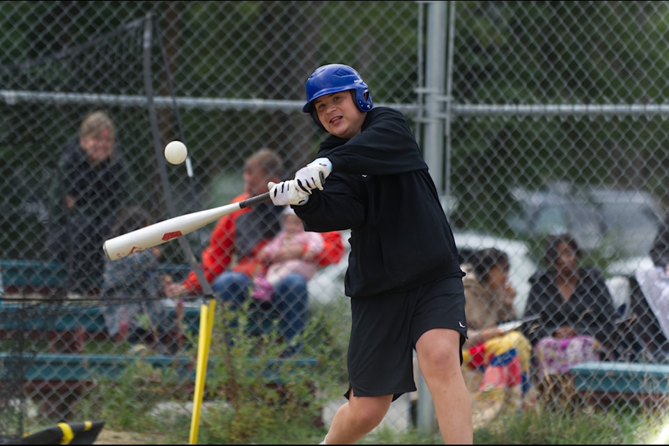 A Little League player connects with the ball during the home-run derby on Aug. 10. (Jake Howarth/Yukon News)