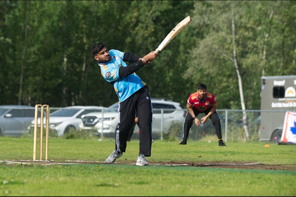A batsman thwacks the bowler’s throw across the field during the championship tournament on Aug. 17. (Jake Howarth/Yukon News)