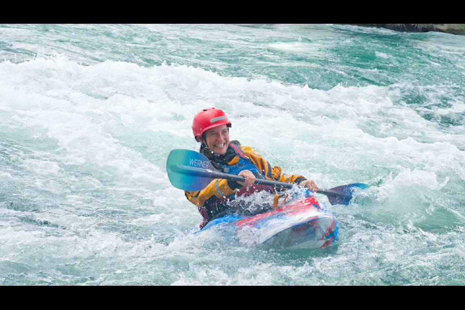 Kayakers and pack rafters surfed the waves underneath the pedestrian bridge in downtown Whitehorse on July 27.