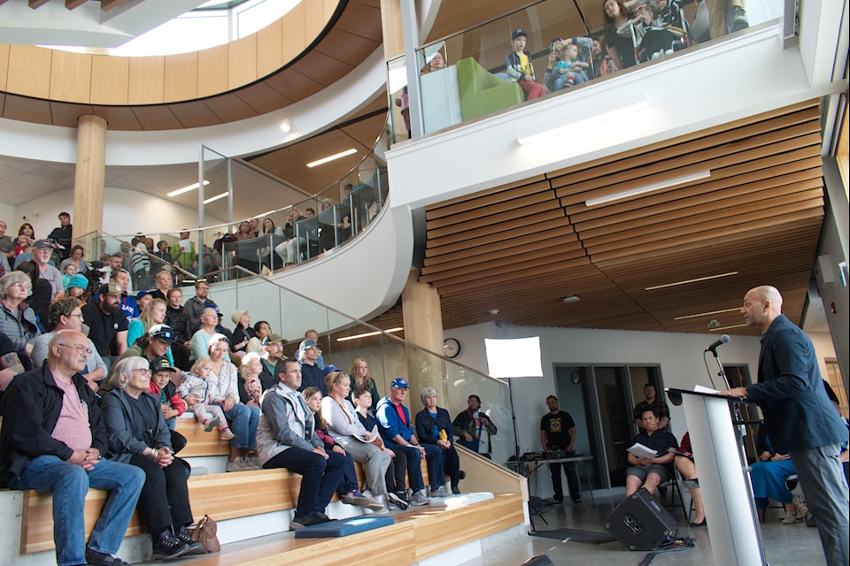 From behind the podium, Premier Ranj Pillai addresses a crowd gathered for the Whistle Bend Elementary School opening ceremony and community visit on May 29, 2024.