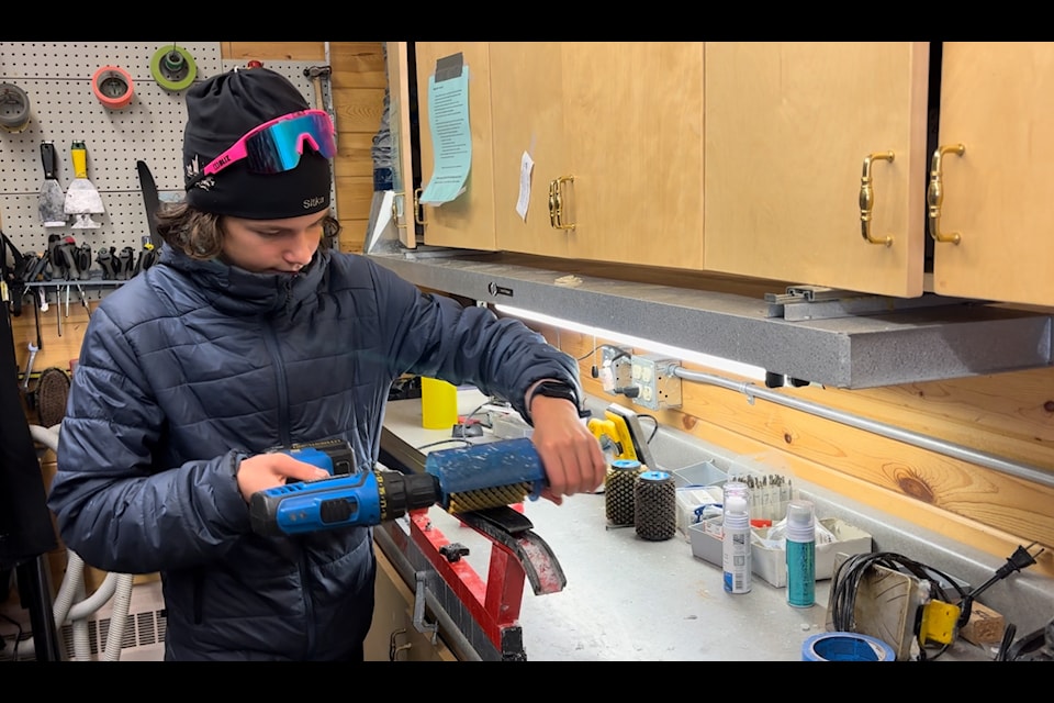 Sitka Land-Gillis applies ski wax with roto brush application. (Submitted)