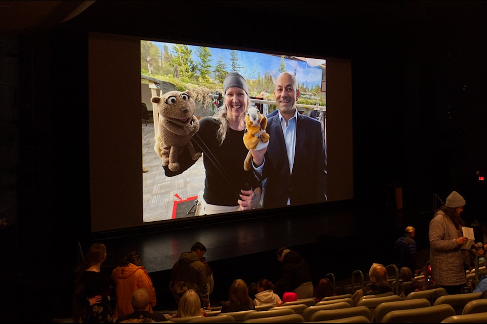 Guests take their seats at the Yukon Arts Centre as behind-the-scenes shots of Northern Tails roll. (Jake Howarth/Yukon News)