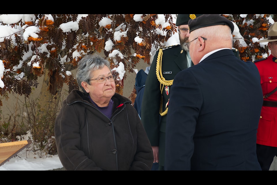 Commissioner Adeline Webber receives the first poppy in the lead up to Remembrance Day 2024 from local Royal Canadian Legion president Joe Mewett in an Oct. 25 ceremony held outside Whitehorse City Hall. (Jim Elliot/Yukon News)
