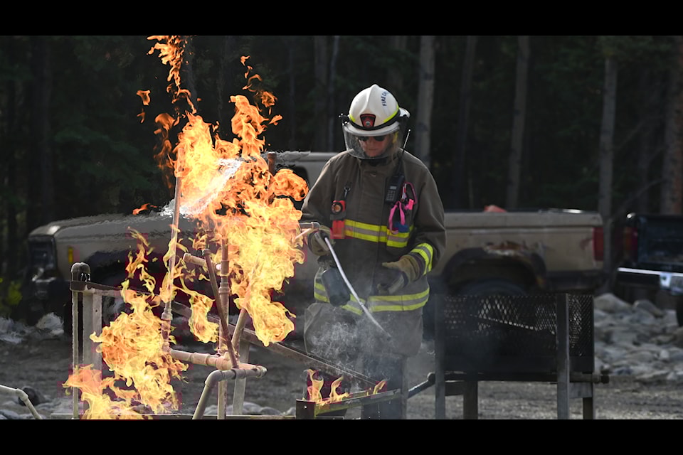Participants at the Ember Fire Academy learn hands-on techniques for extinguishing fires. (Jake Howarth/Yukon News)