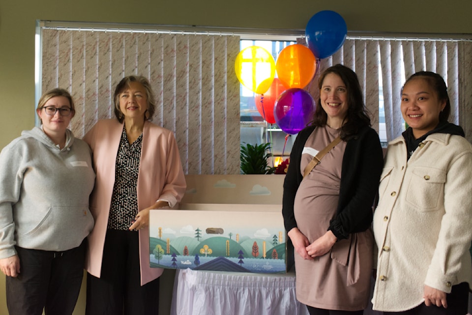 Health Minister Tracy-Anne McPhee, second from the left, poses with three soon-to-be moms who were the first recipients of "baby baskets" in the territory. 