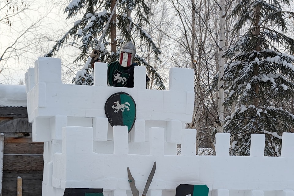 John Hanulik poses for a photo in armour atop the tower of the snow castle he constructed outside his Dawson City home. (Tony Berger/Submitted)